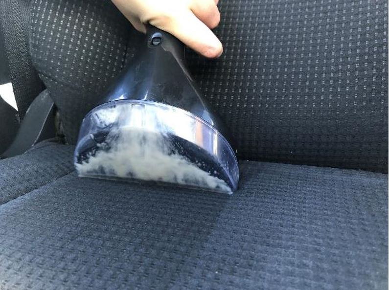 Cleaning a car seat wit the Bissell SpotClean ProHeat Professional Carpet & Upholstery Washer.