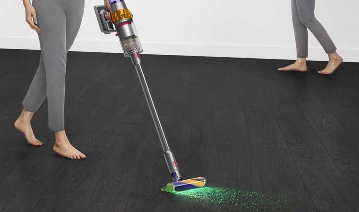 A person using the Dyson V15 Detect Total Clean.