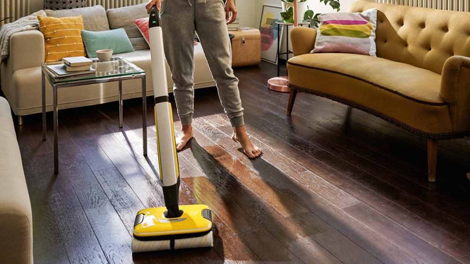 Person cleaning a living room with the Karcher FC7 Hard Floor Cleaner.