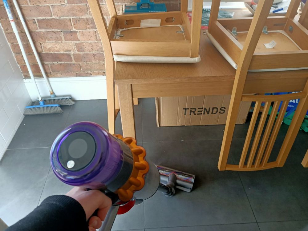 Our reviewer vacuuming the floor with the Dyson V15S Submarine.
