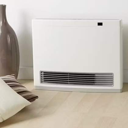Minimalist white gas heater against a light wall in a contemporary space