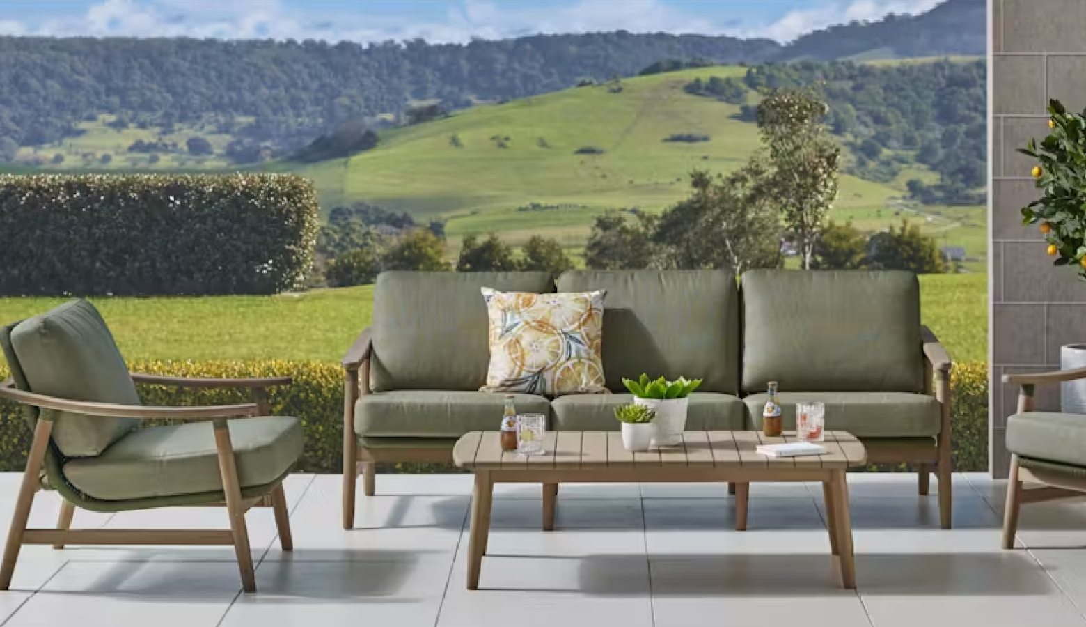 Harvey Norman exclusive Masaya 4-piece outdoor lounge setting with olive-green cushions and eucalyptus timber frames. 