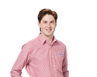 Friendly Harvey Norman team member in light blue uniform shirt