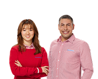 Two smiling Harvey Norman team members in uniform, ready to help with camera advice