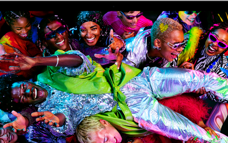 Colourful screen on a MacBook Pro of a person crowd-surfing at a party, showcasing the vibrant Liquid Retina XDR display